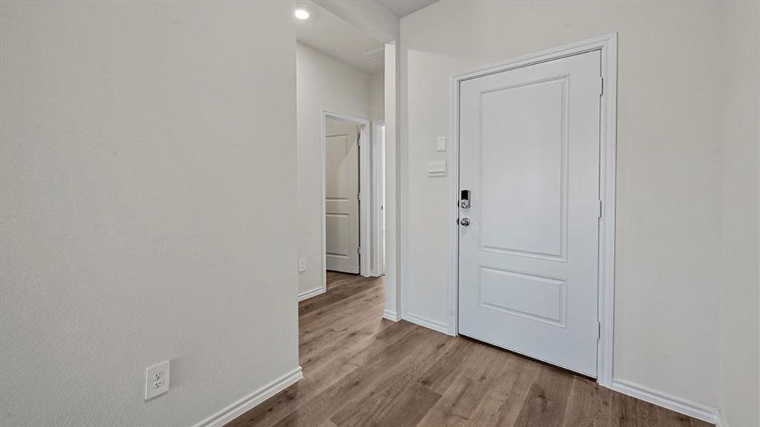 Foyer featuring light wood finished floors and recessed lighting
