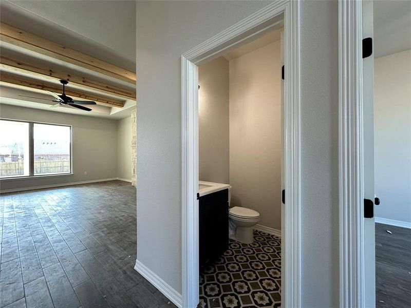 Half bath with vanity, ceiling fan, dark wood finished floors, and beam ceiling Half bath with vanity, ceiling fan, dark wood finished floors, and beam ceiling