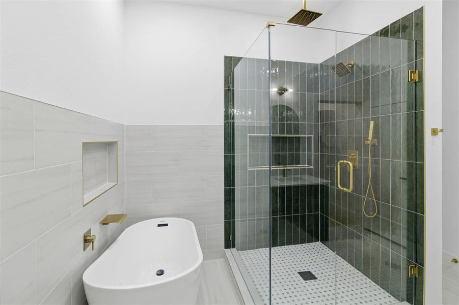 Full bathroom with a soaking tub, a stall shower, and tile walls