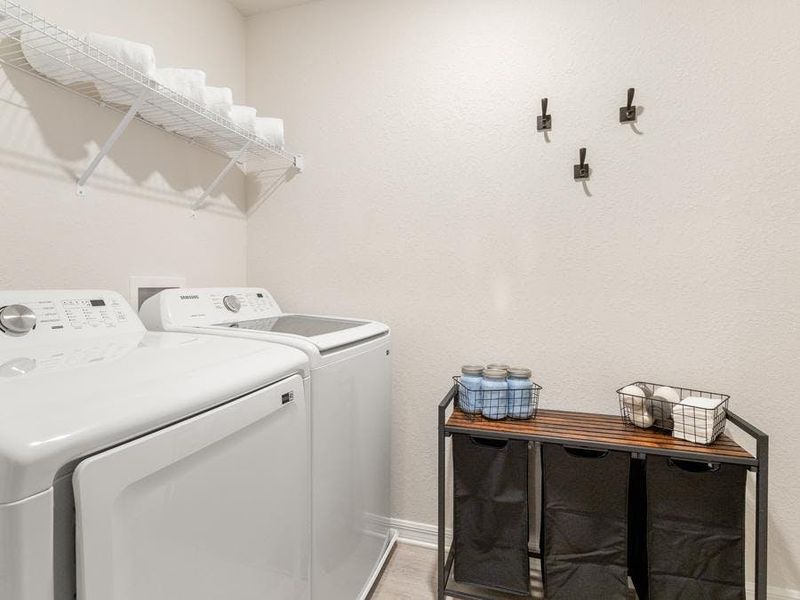 A dedicated laundry room is conveniently located upstairs, near the bedrooms - Flora townhome by Highland Homes
