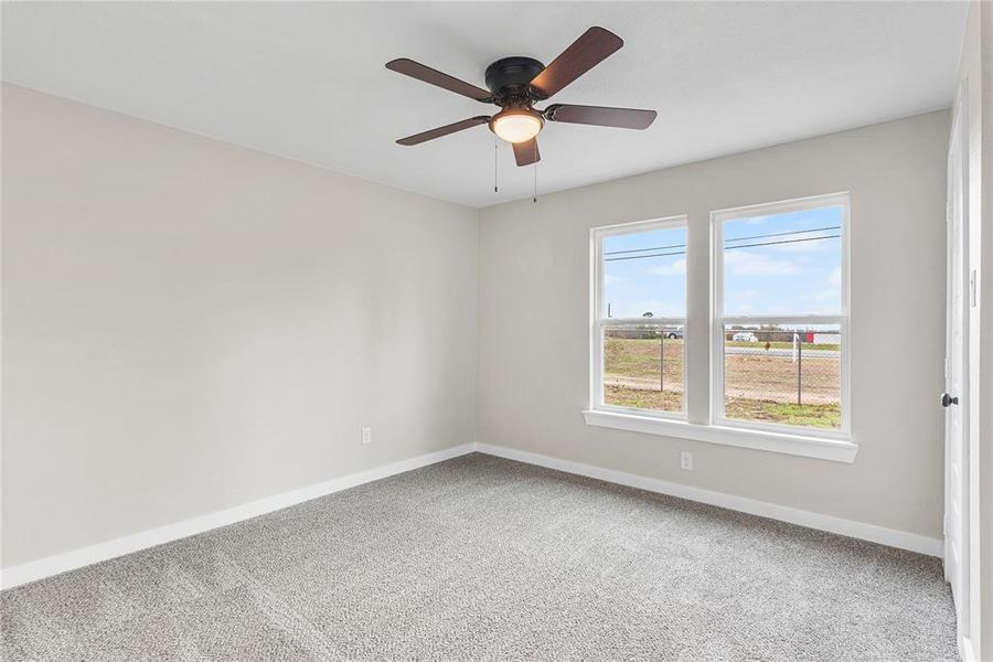 Spare room with carpet flooring and ceiling fan