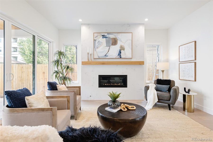 Living room opens to kitchen, dining, backyard patio and outdoor fireplace