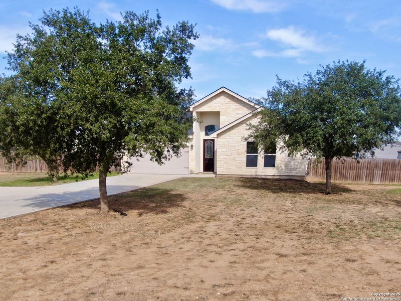 Front exterior of a new home in , Lytle, TX, highlighting curb appeal (Image 20).