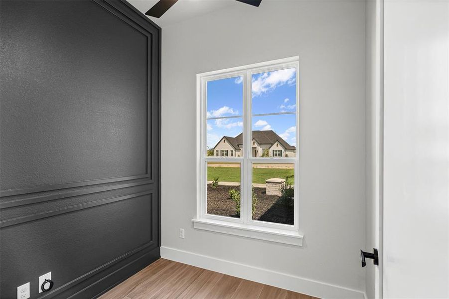 Unfurnished room with light wood-style floors and a ceiling fan Unfurnished room with light wood-style floors and a ceiling fan