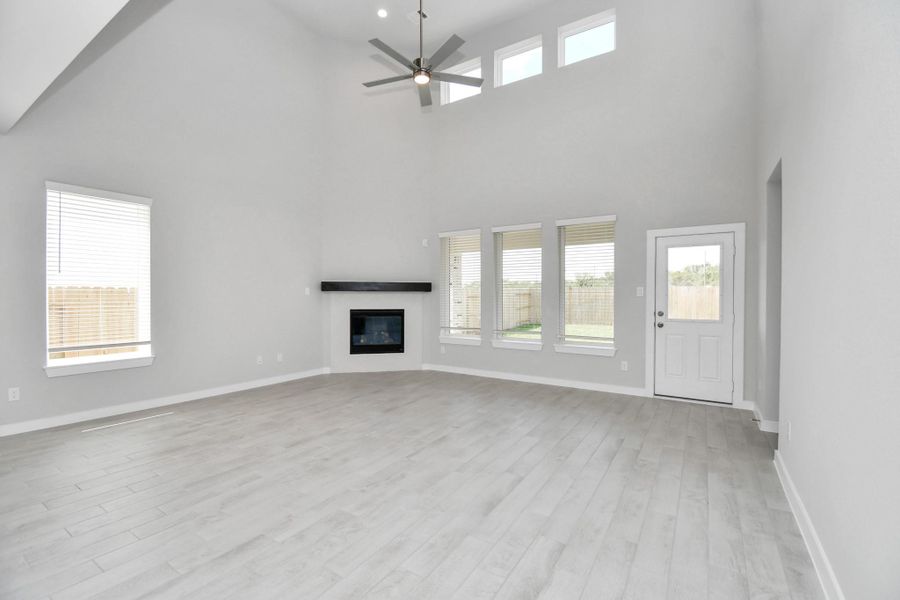 Family room flooded with natural light through the expansive windows. The premium tile flooring adds a touch of luxury to the space, creating the perfect setting for relaxing moments and cherished gatherings with loved ones. Family room flooded with natural light through the expansive windows. The premium tile flooring adds a touch of luxury to the space, creating the perfect setting for relaxing moments and cherished gatherings with loved ones.