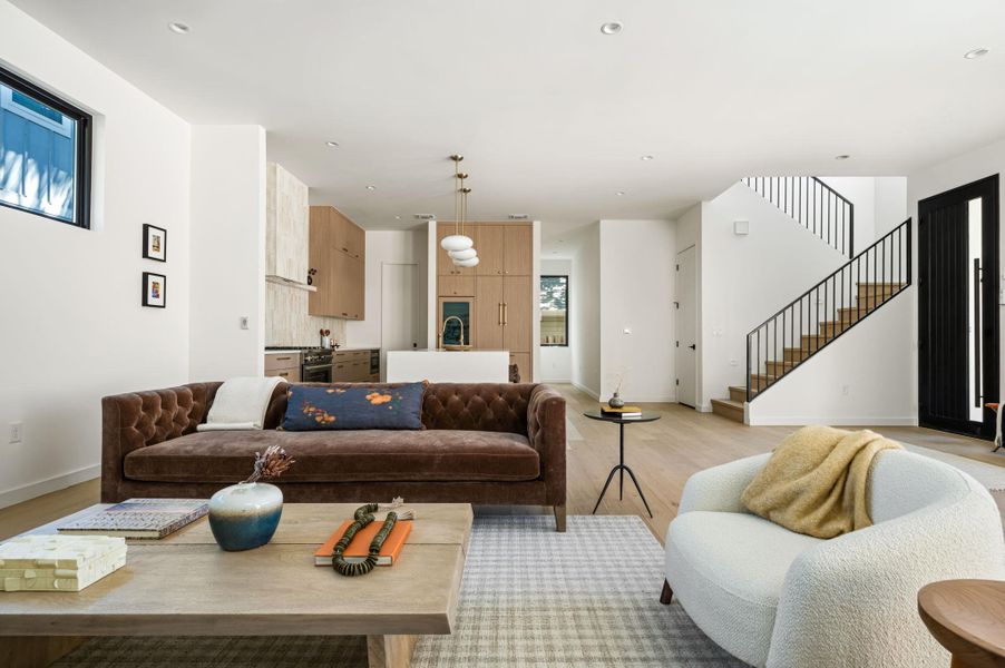 Clean lines and warm wood floors define this light-filled, open-concept main level.