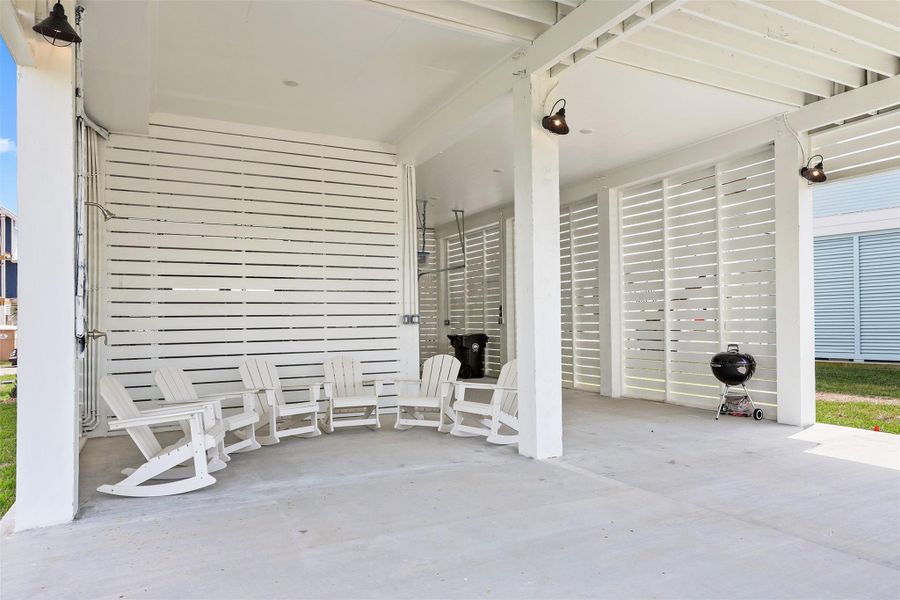Another perspective of the under-home patio space reveals its size and functionality, with room to relax, entertain, or store beach gear with ease.