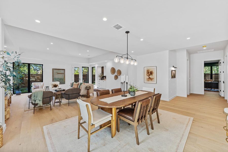 Dining space with recessed lighting, healthy amount of natural light, and light wood-style flooring