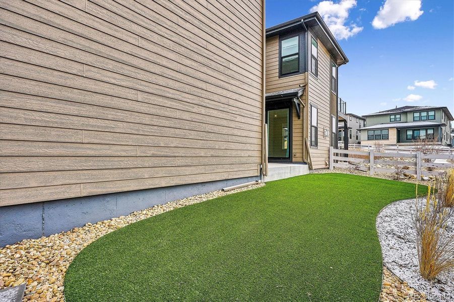Side yard view of low-maintenance emerald green turf Side yard view of low-maintenance emerald green turf