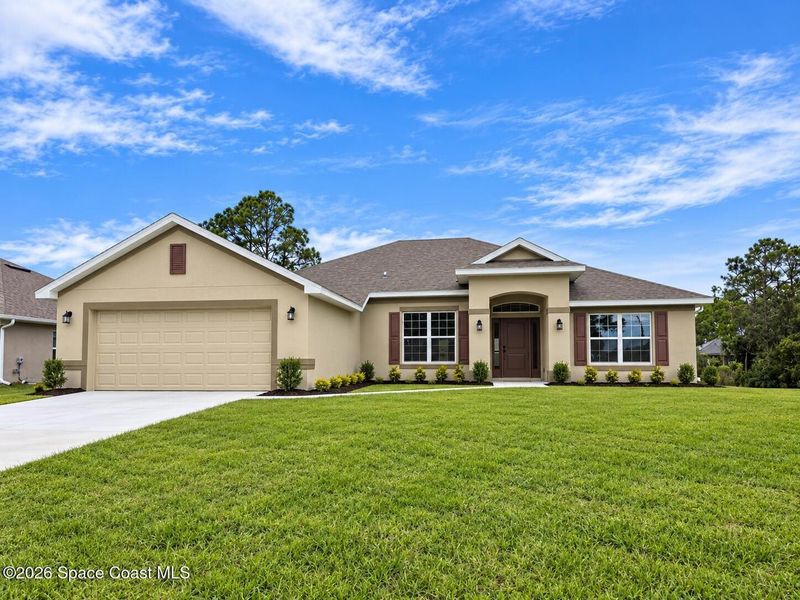 Front exterior of a new home in Palm Bay, Palm Bay, FL, highlighting curb appeal (Image 1). Front exterior of a new home in Palm Bay, Palm Bay, FL, highlighting curb appeal (Image 1).