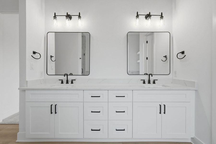 Spa-inspired primary bath with dual sinks, soaking tub, and walk-in shower designed for comfort and relaxation.