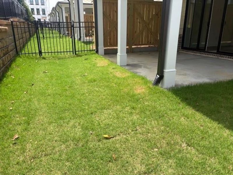 I love this fenced in backyard with covered patio. Pictures represent a previously built home, not the actual home.