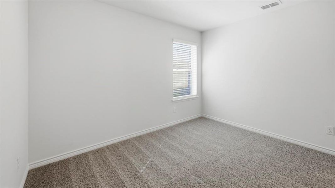 Carpeted empty room featuring baseboards