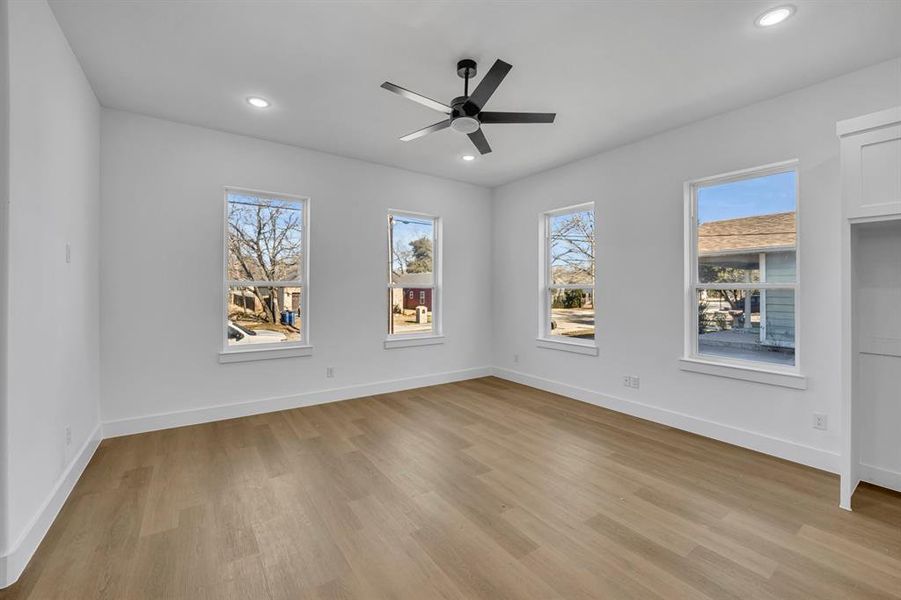 Unfurnished room with ceiling fan and light wood-type flooring