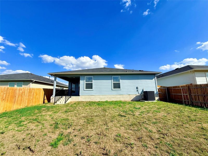 Rear view of property with a fenced backyard and a patio area Rear view of property with a fenced backyard and a patio area