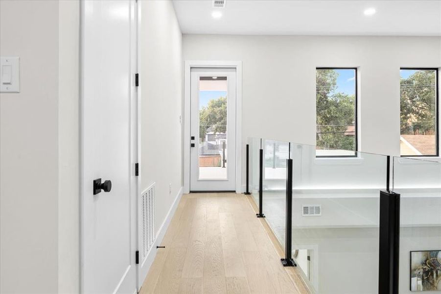 Hallway with light hardwood / wood-style floors