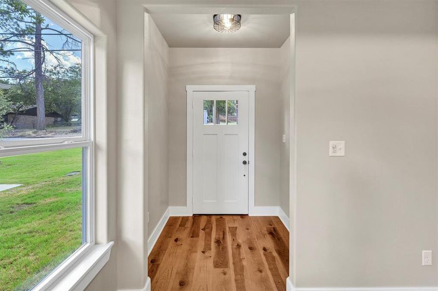 Entryway featuring wood finished floors and baseboards Entryway featuring wood finished floors and baseboards