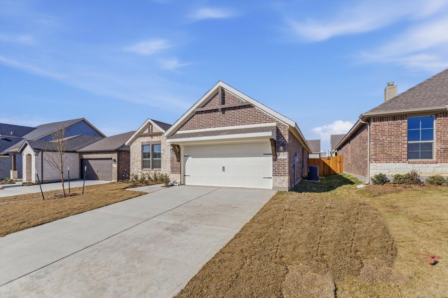 Front exterior of a new home in Liberty Pointe, Gainesville, TX, highlighting curb appeal (Image 16).