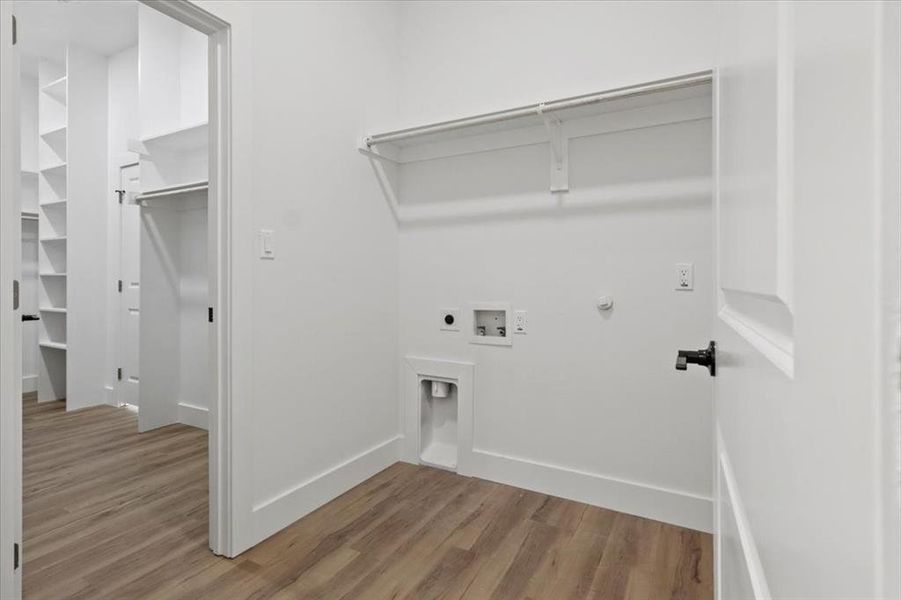 Washroom featuring gas dryer hookup, light wood-type flooring, electric dryer hookup, and hookup for a washing machine