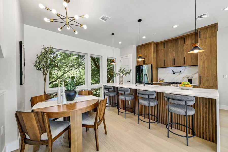 Plenty of space to gather for a meal. (This is Unit #2 - each Unit has the same layout, however a few differing details such as light fixtures, custom cabinet/backsplash/tile colors)