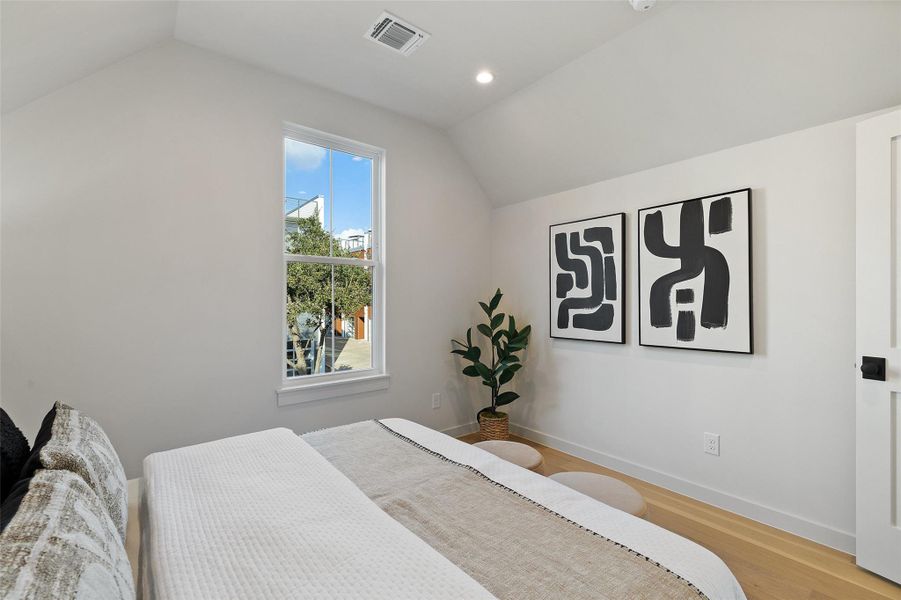 Bedroom featuring vaulted ceiling and light hardwood / wood-style flooring