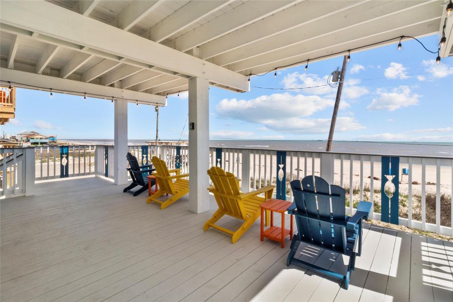 Listen and watch the waves under the BEACHFRONT 1st floor covered balcony. Upgraded painted decking and TREX handrails. Notice the ambience string lights above wired to a switch inside the front door for ease of use.