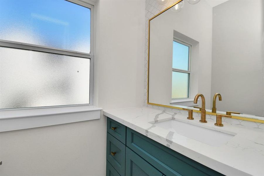 Stylish half-bath with elegant finishes, perfect for guests.