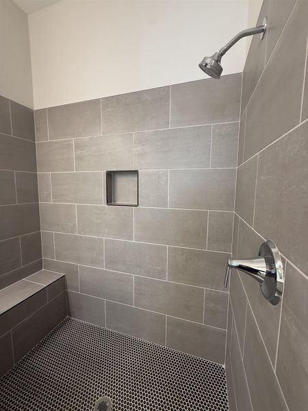 Bathroom featuring tiled shower