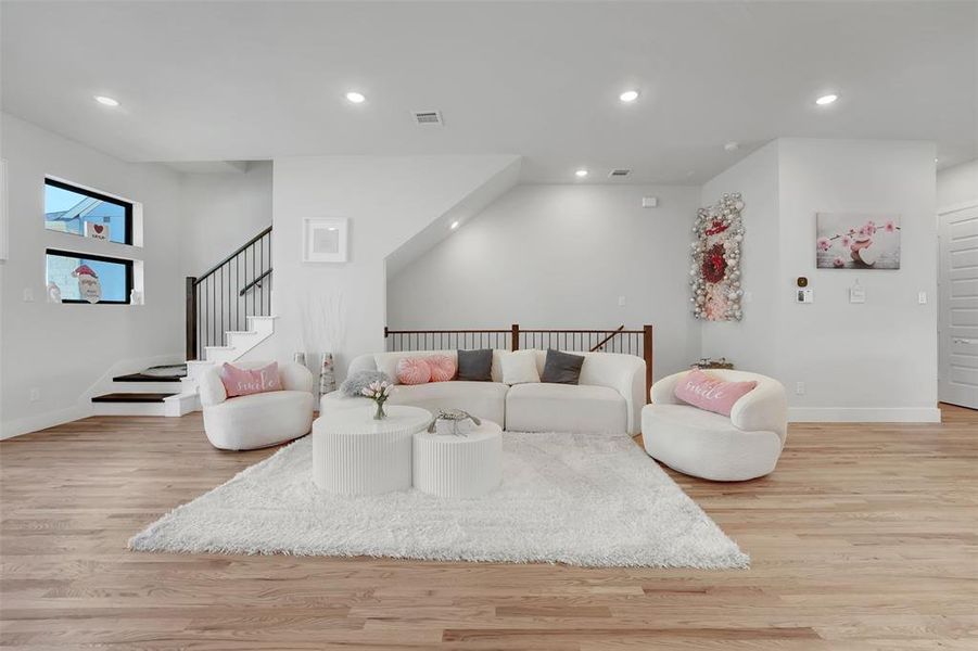 Living room with light hardwood / wood-style flooring