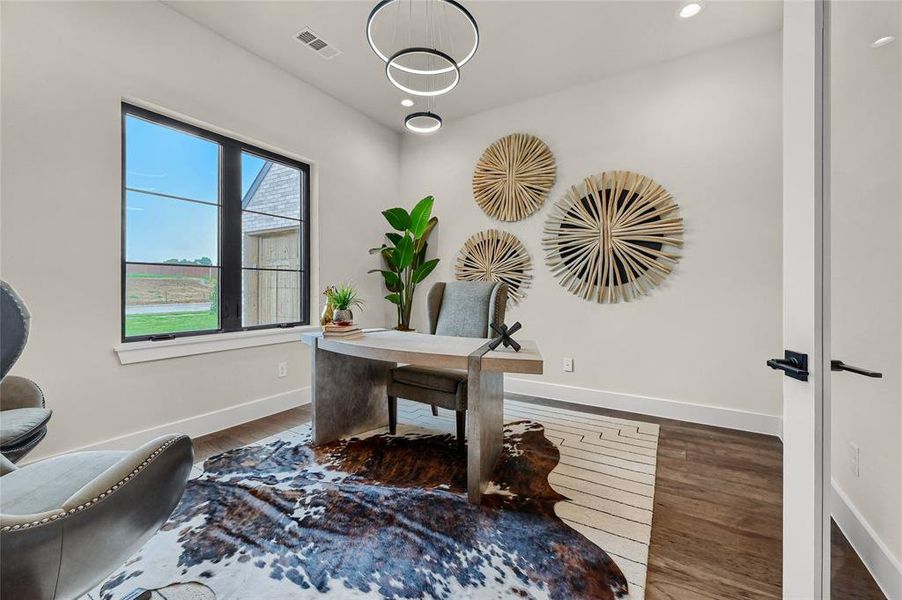 Office features a modern chandelier