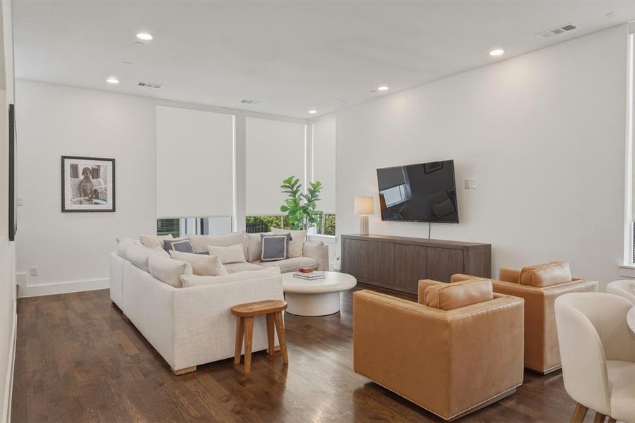 Living room featuring dark wood finished floors and recessed lighting