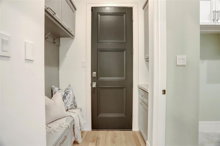 Mudroom/garage:  As you enter the garage, you’re met with a luxury epoxy finish and glass /polished nickel door handle into convenient mudroom with a perfectly located cabinet for additional drop offs.