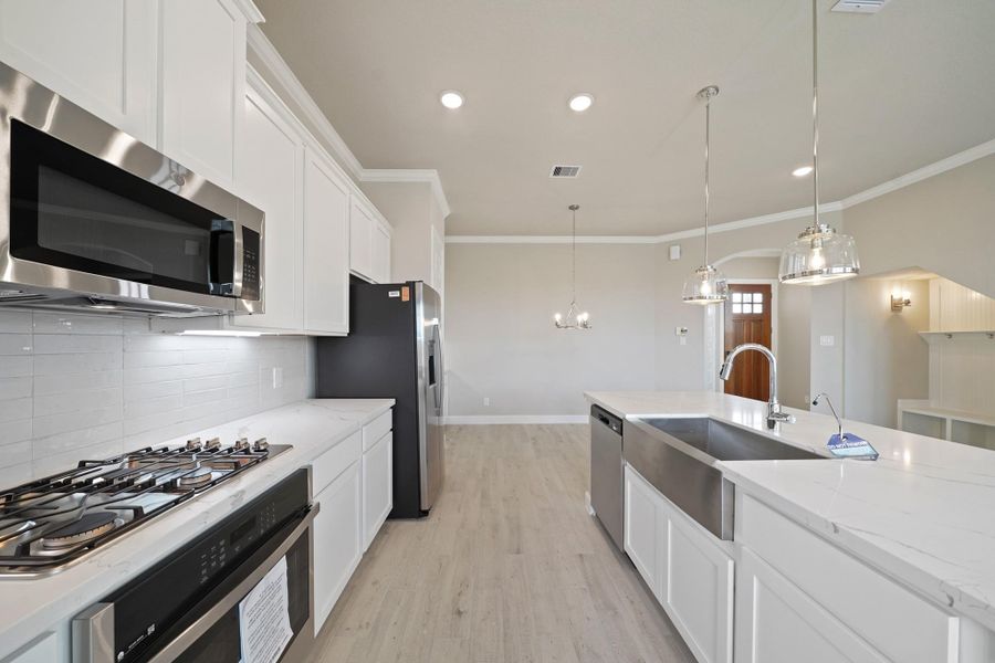 Lovely kitchen with white cabinets and quartz countertops