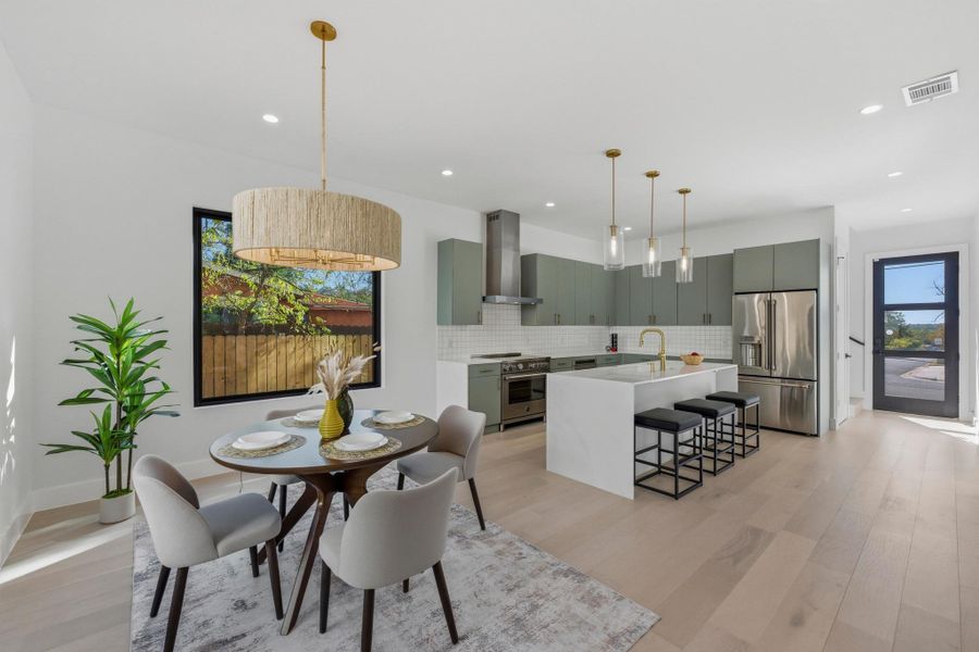 Dining area with plenty of natural light and light wood-style flooring