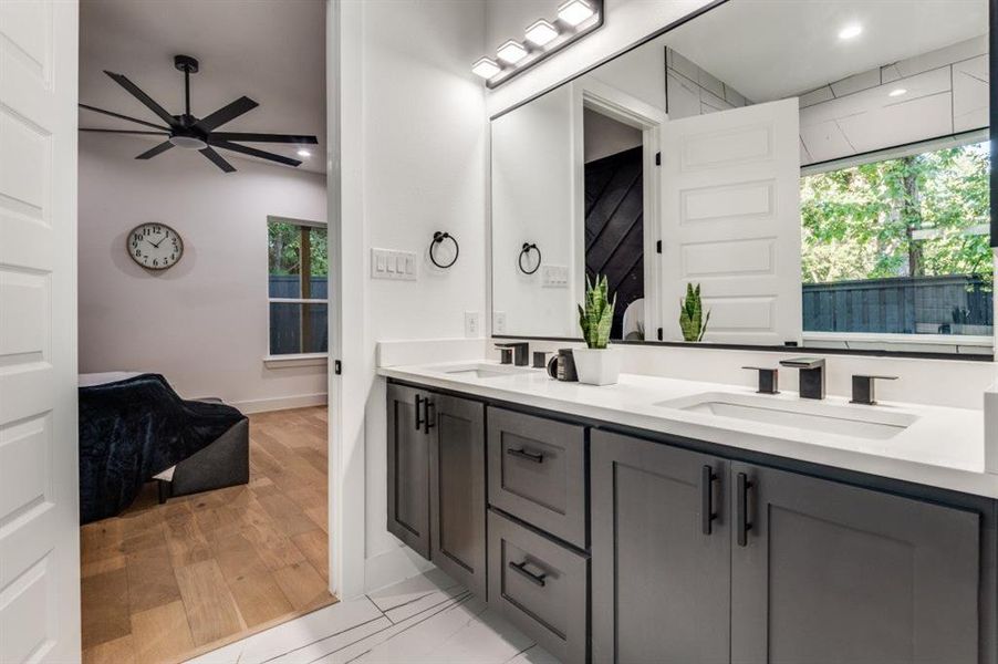 Bathroom featuring double vanity, light wood-style floors, a ceiling fan, and recessed lighting Bathroom featuring double vanity, light wood-style floors, a ceiling fan, and recessed lighting
