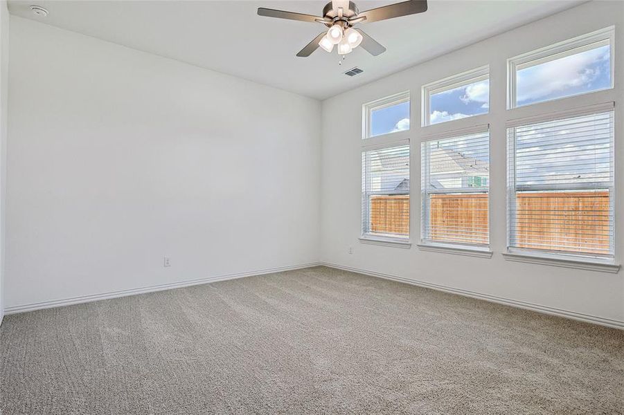 Empty room with carpet flooring and ceiling fan