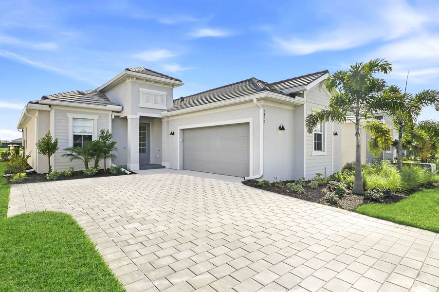 Front exterior of a new home in The National Golf & Country Club: Executive Homes, Ave Maria, FL, highlighting curb appeal (Image 1). Front exterior of a new home in The National Golf & Country Club: Executive Homes, Ave Maria, FL, highlighting curb appeal (Image 1).