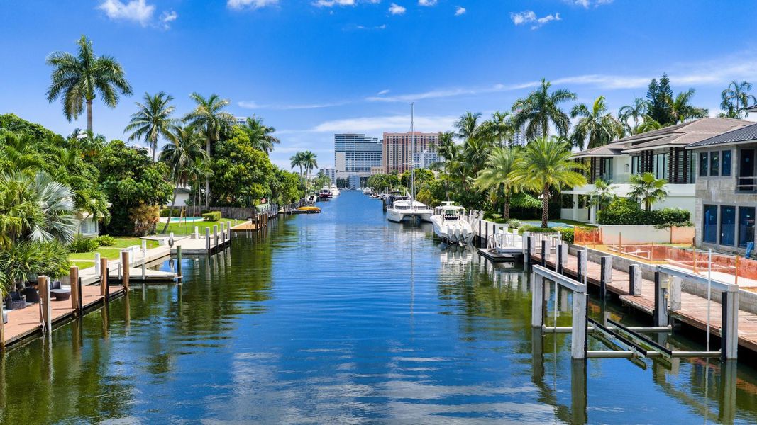 A long canal shot showcasing deep-water dockage and prime waterfront estates set against a backdrop of the oceanfront skyline. A long canal shot showcasing deep-water dockage and prime waterfront estates set against a backdrop of the oceanfront skyline.