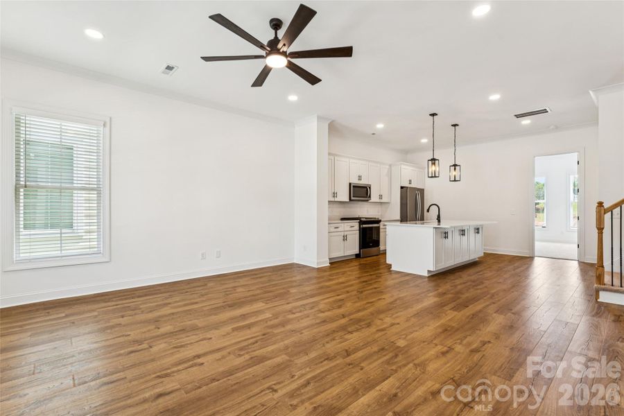 Open concept living area with tall ceilings, crown molding, tons of natural light, etc.