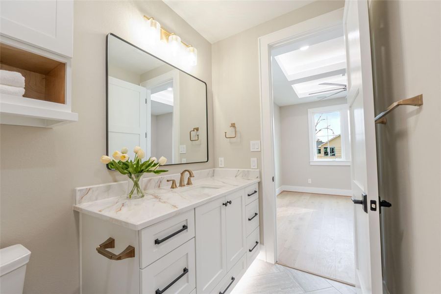 Half bath with vanity and a skylight