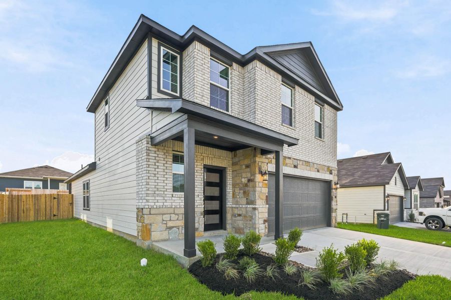 Front exterior of a new home in Reveille Estates, Bryan, TX, highlighting curb appeal (Image 20).