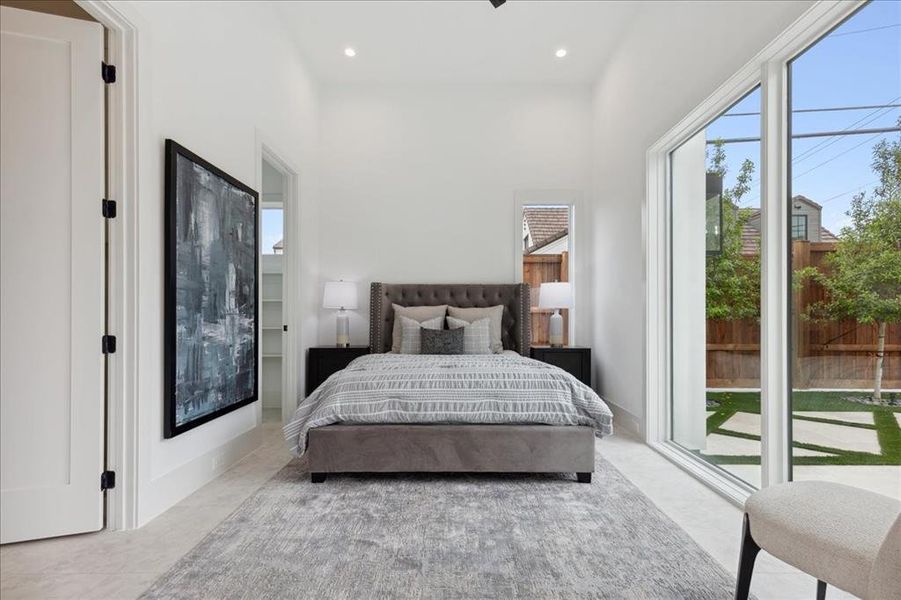 Tiled bedroom with access to outside and a high ceiling