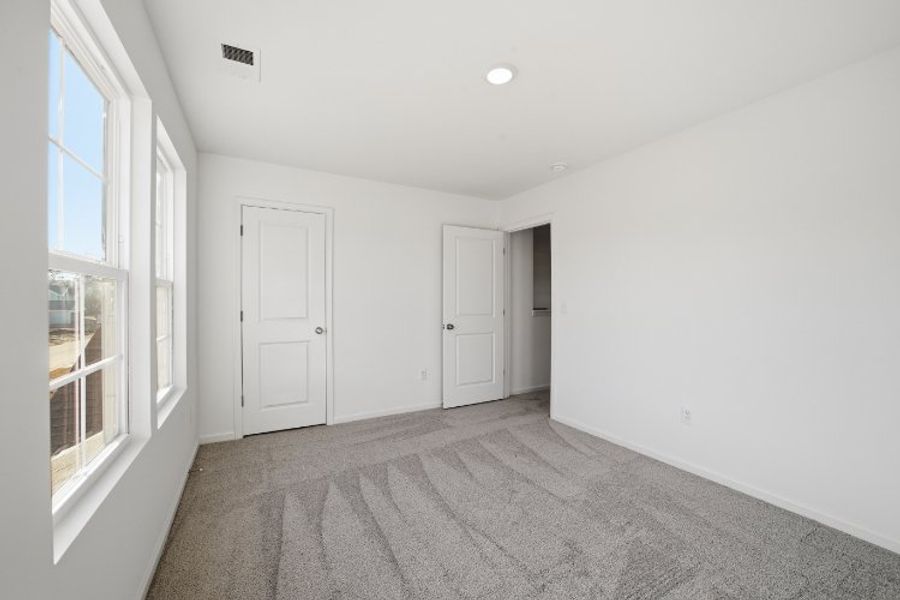 A hallway with white doors. A hallway with white doors.