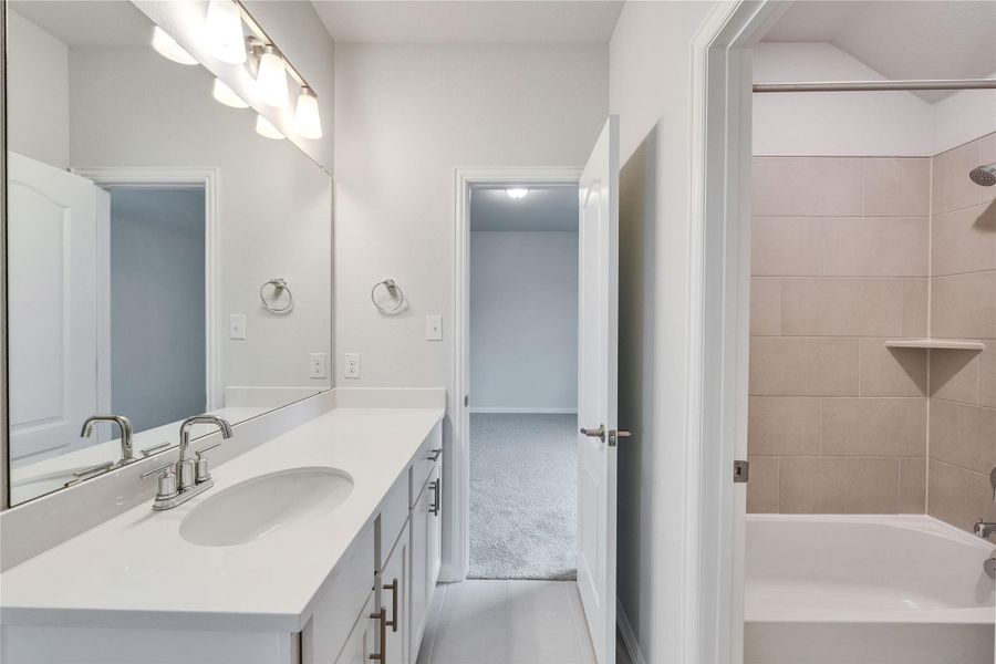 Full bath with vanity, bathtub / shower combination, and tile patterned flooring Full bath with vanity, bathtub / shower combination, and tile patterned flooring