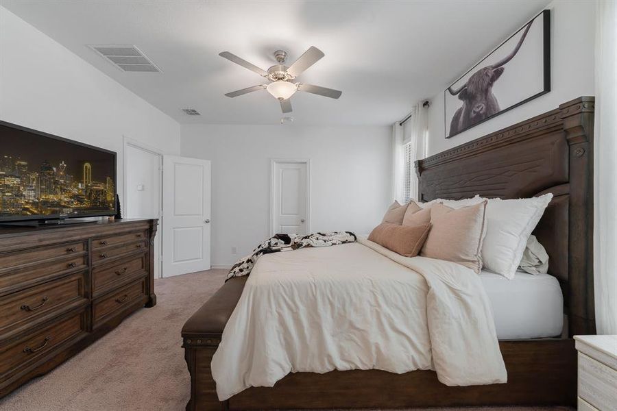 Carpeted bedroom with ceiling fan