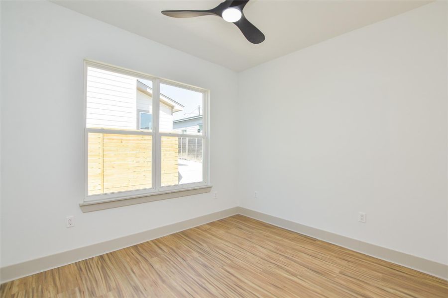 Main level bedroom. Ceiling fan, premium luxury vinyl flooring. Full bathroom just across the hallway.