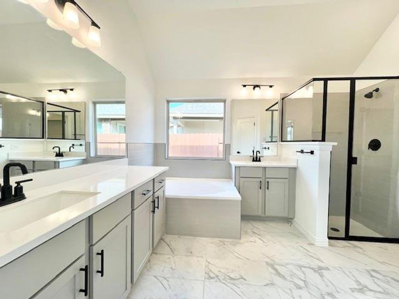 Full bathroom with a stall shower, a garden tub, marble finish floor, and a sink Full bathroom with a stall shower, a garden tub, marble finish floor, and a sink