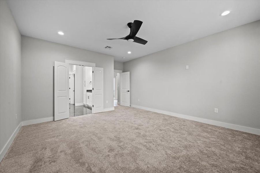 Unfurnished bedroom featuring carpet, recessed lighting, and a ceiling fan