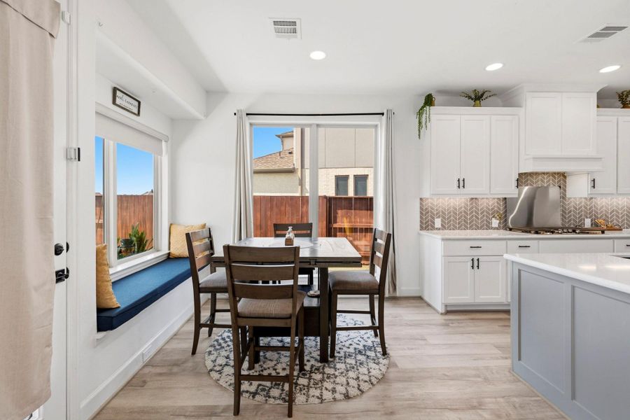 Start your day off right with a cup of coffee sitting with your family in the breakfast area! Featuring large windows, built-in seating, beautiful flooring, recessed lighting and access to the covered back patio!