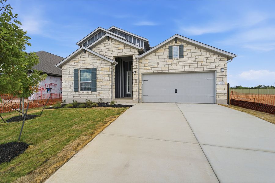 Front exterior of a new home in Santa Rita Ranch, Liberty Hill, TX, highlighting curb appeal (Image 26).